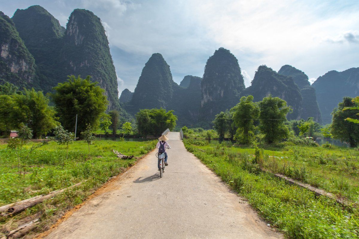 Enjoy a blissful bike ride through the fairytale mountains around Yangshuo..