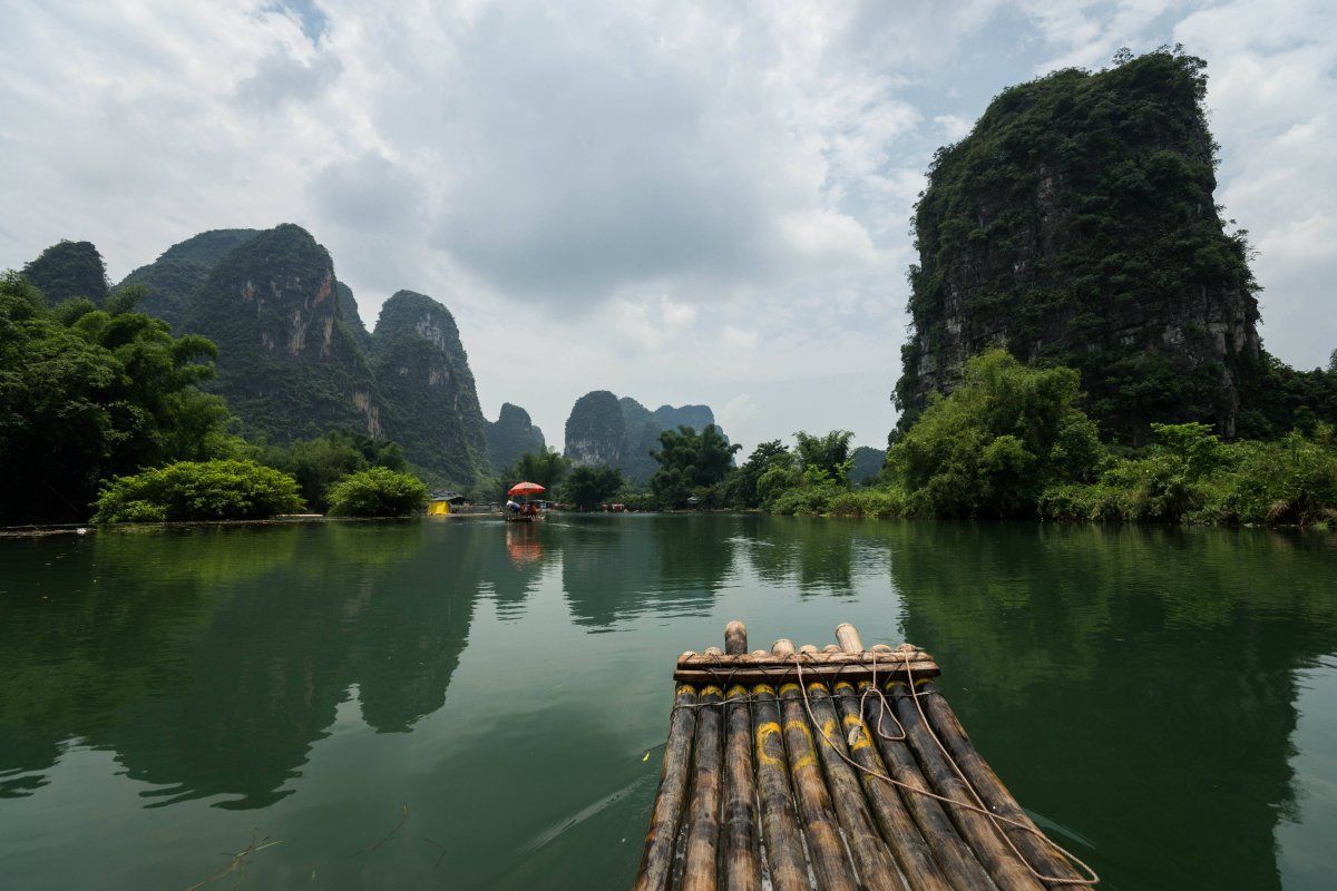Take a bamboo raft along the river when in Yangshuo.