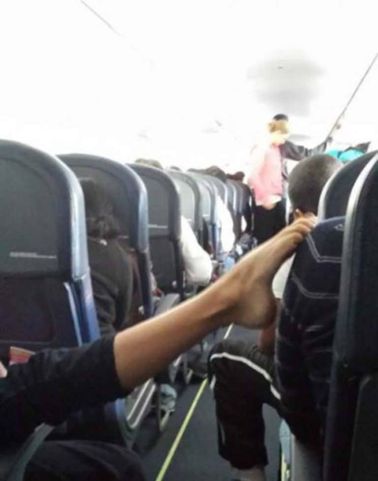 Feet Stetched Across Aisle on Plane