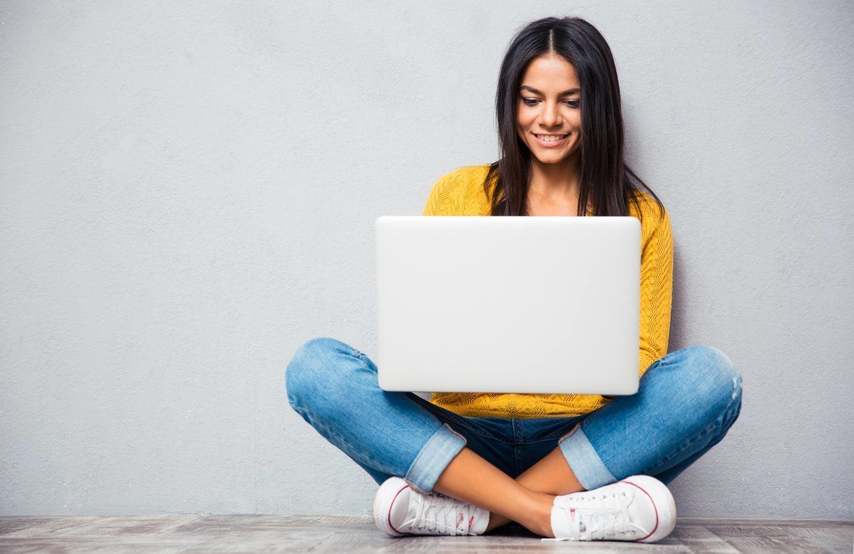Woman Sitting On The Floor Using Laptop