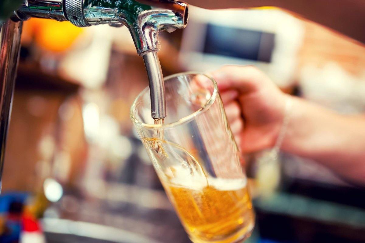 Close-Up Of Barman Hand At Beer Tap