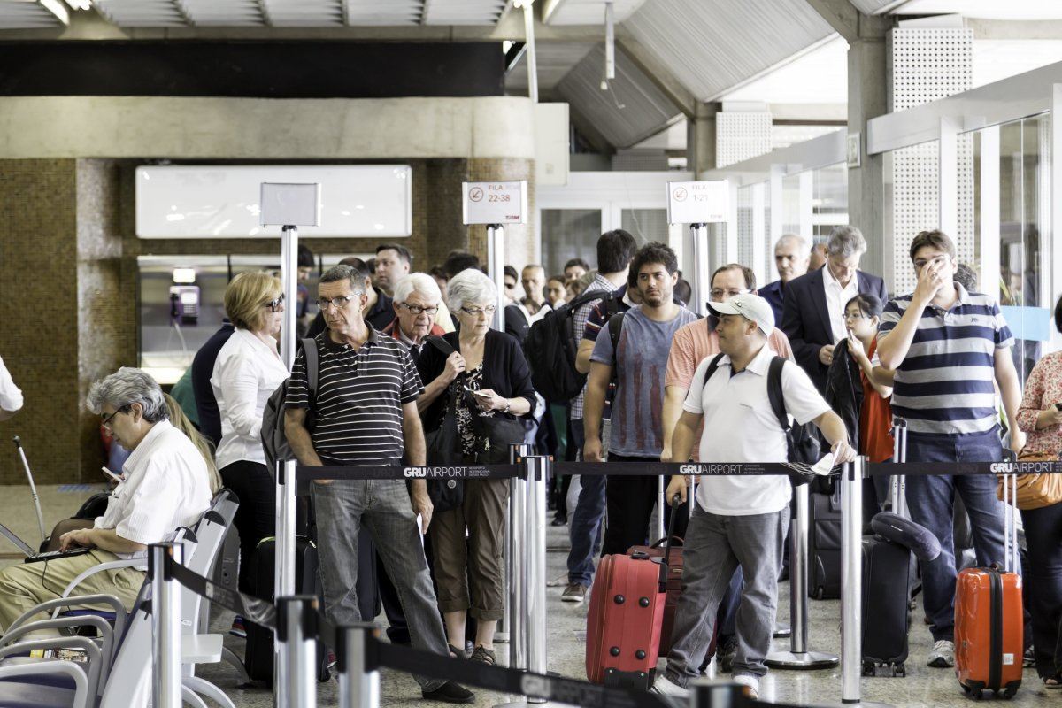 Passengers Wait For Check-In In at Airport