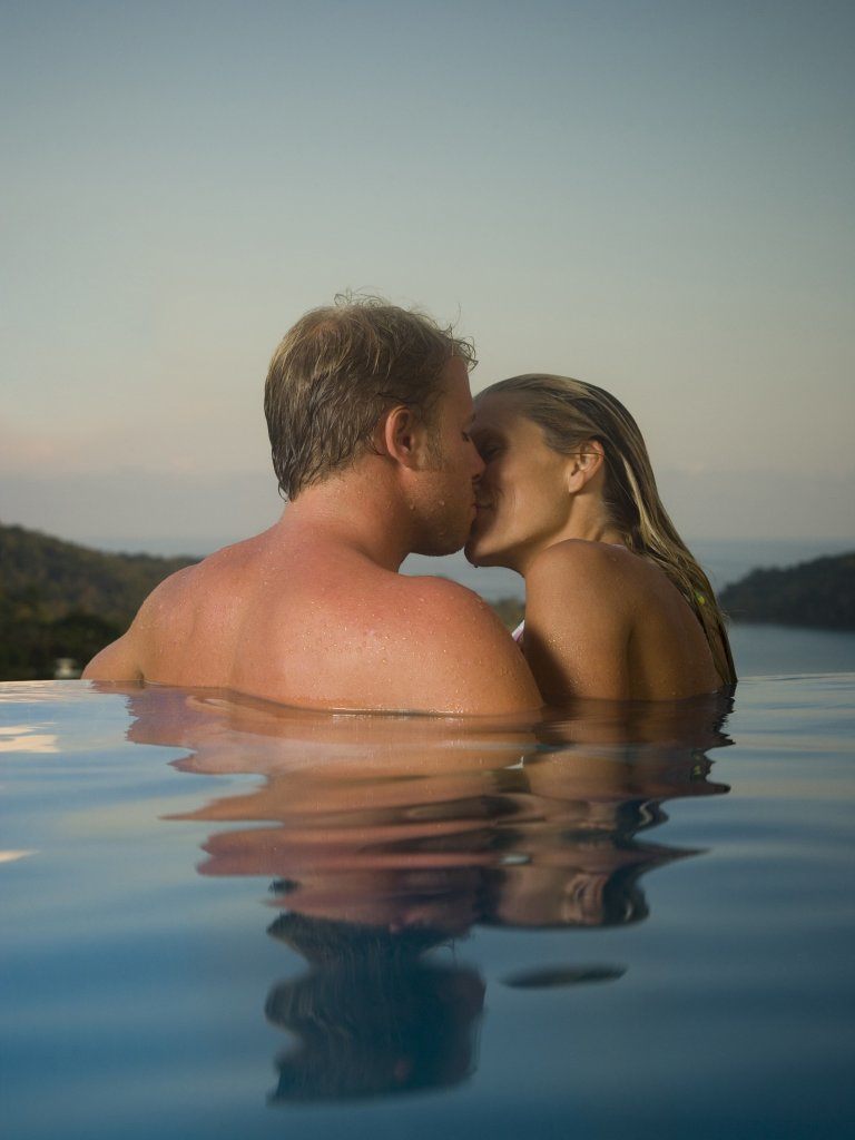 Romantic Couple Skinny Dipping in Pool. shutterstock.com. 