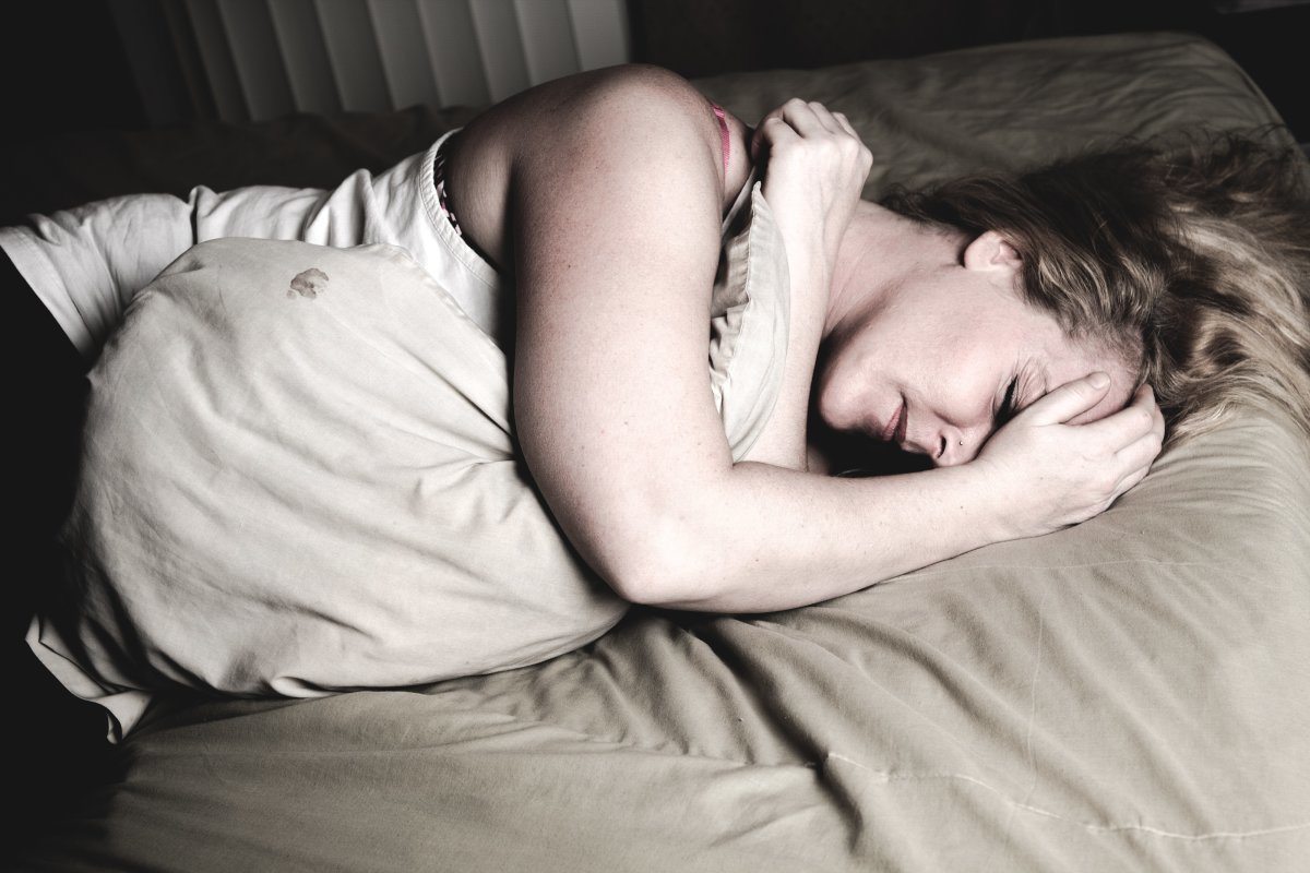A Woman Lying Down On Bed