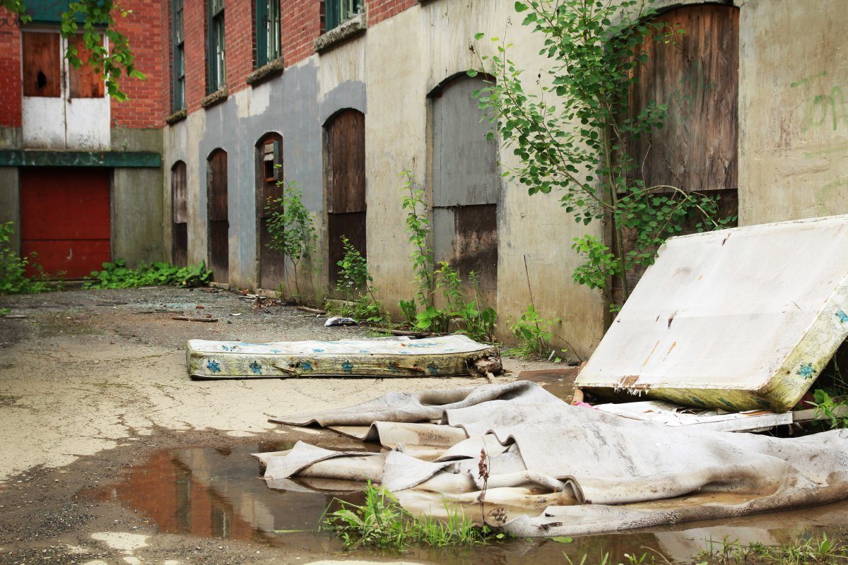 Abandoned Building with Mattresses outside
