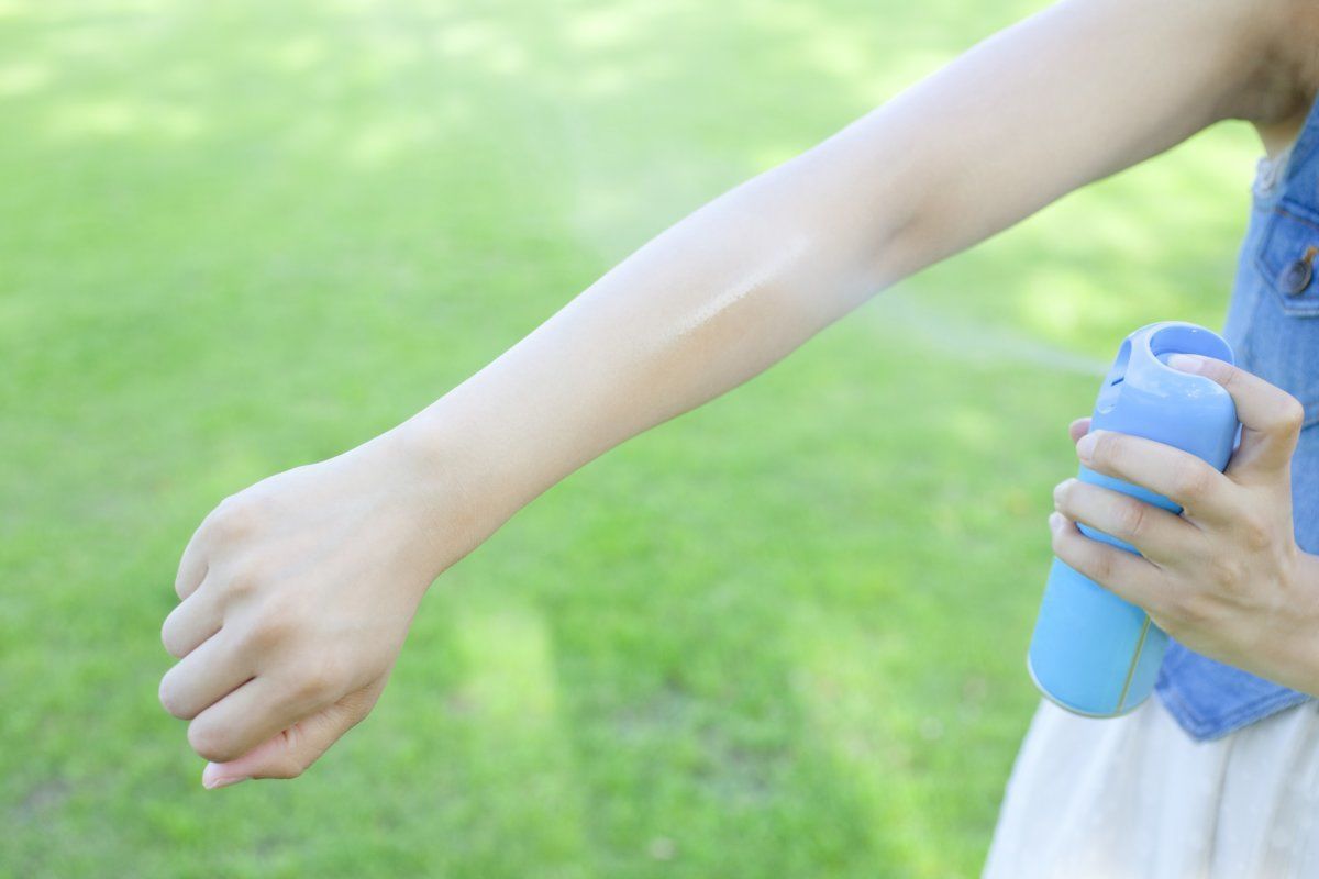 Hand Of The Woman Using The Insect Repellent