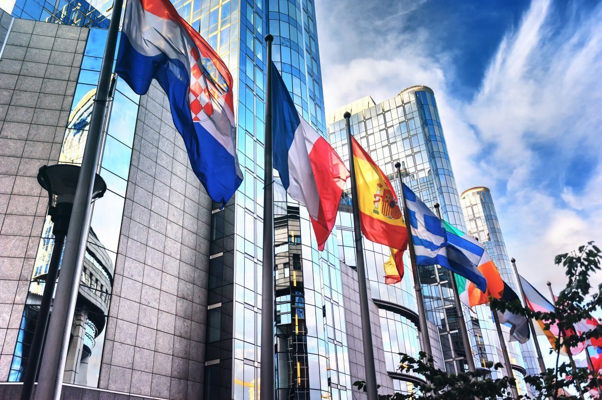 Waving Flags In Front Of European Parliament Building. Brussels, Belgium