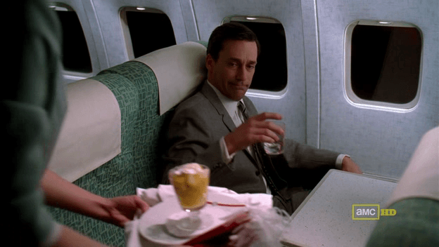 Don Draper drinking on plane
