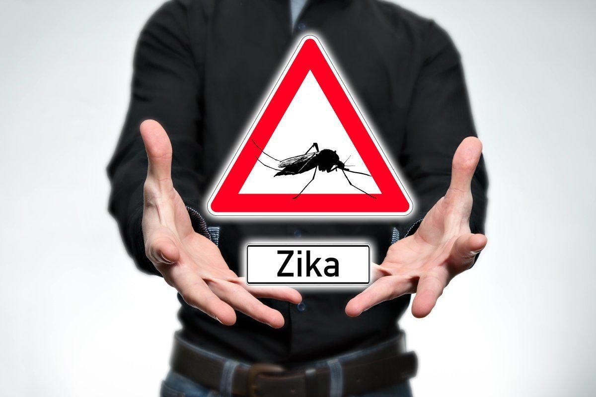 Man Holding A Warning Sign for Zika