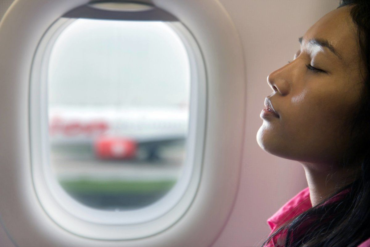 Young Beautiful Woman Resting On Airplane