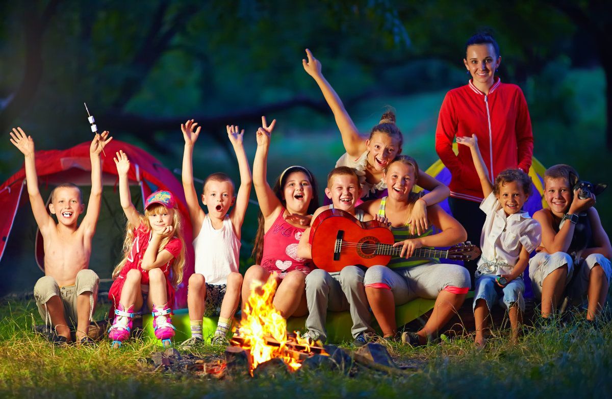Kids Singing Songs Around Camp Fire