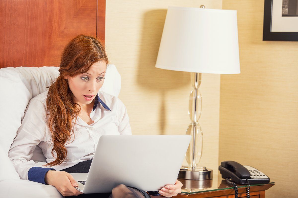 Shocked Young Business Woman Using Laptop