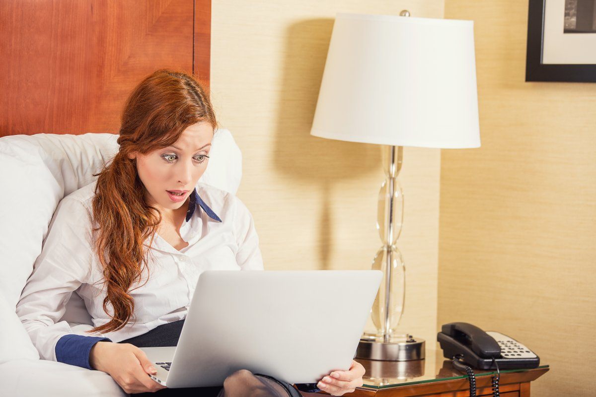 Shocked Young Business Woman Using Laptop