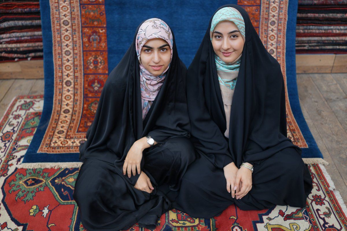 Iranian Girls in Persian Carpet Store. shutterstock.com. 
