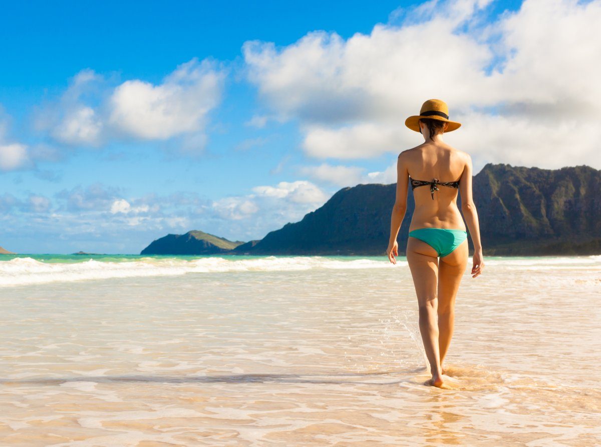 Woman Walking On Sand Beach In Hawaii