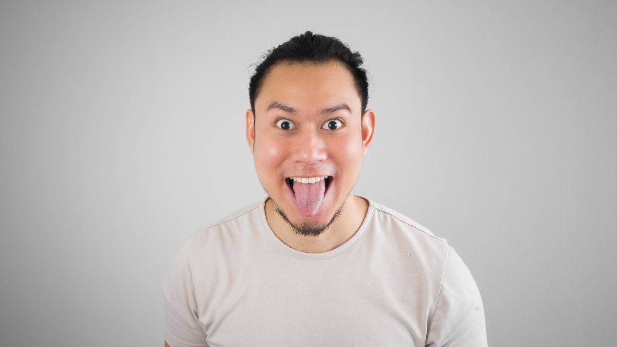 Asian Man Is Sticking The Tongue Out.