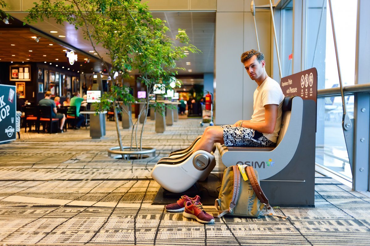 Passenger In Massage Chair At Airport
