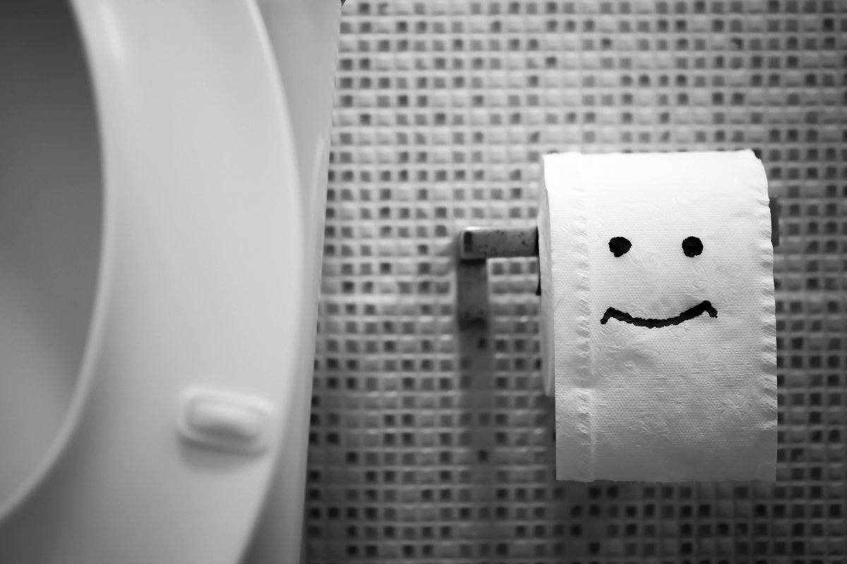 White Toilet Bowl And Toilet Paper.