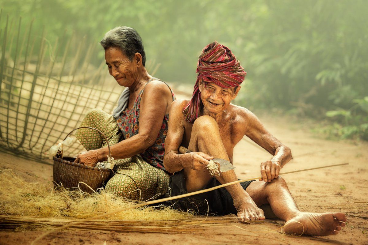 Elderly Husband And Wife Working Craft With Bamboo.