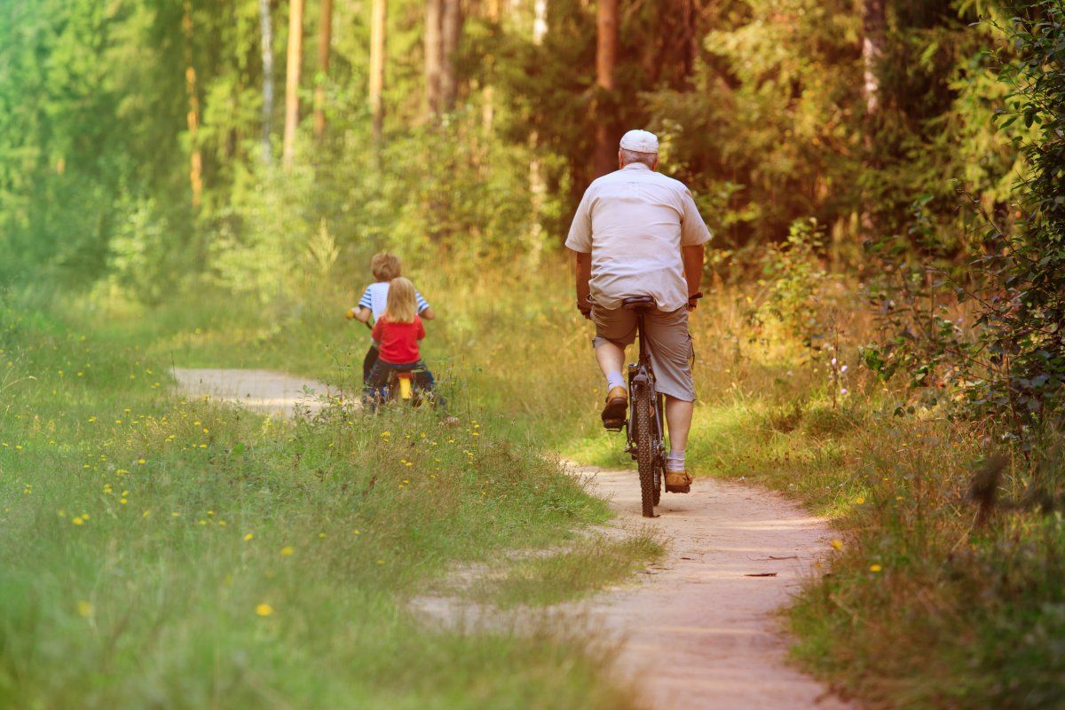 Active Senior Grandkids Riding Bikes Nature