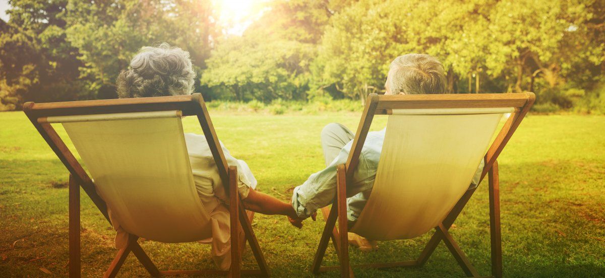 Happy Mature Couple Sitting Park Holding