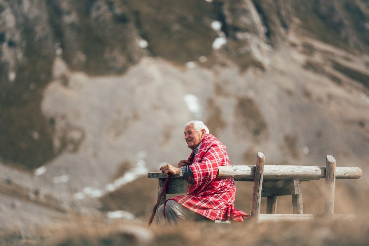 Lonely Senior Man Sitting On Bench