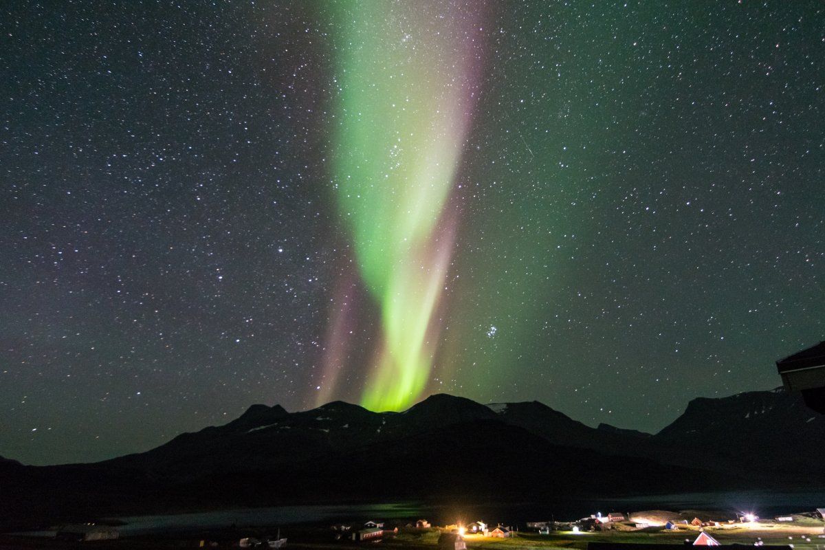 Northern Lights Reflexing On Fjord Greenland