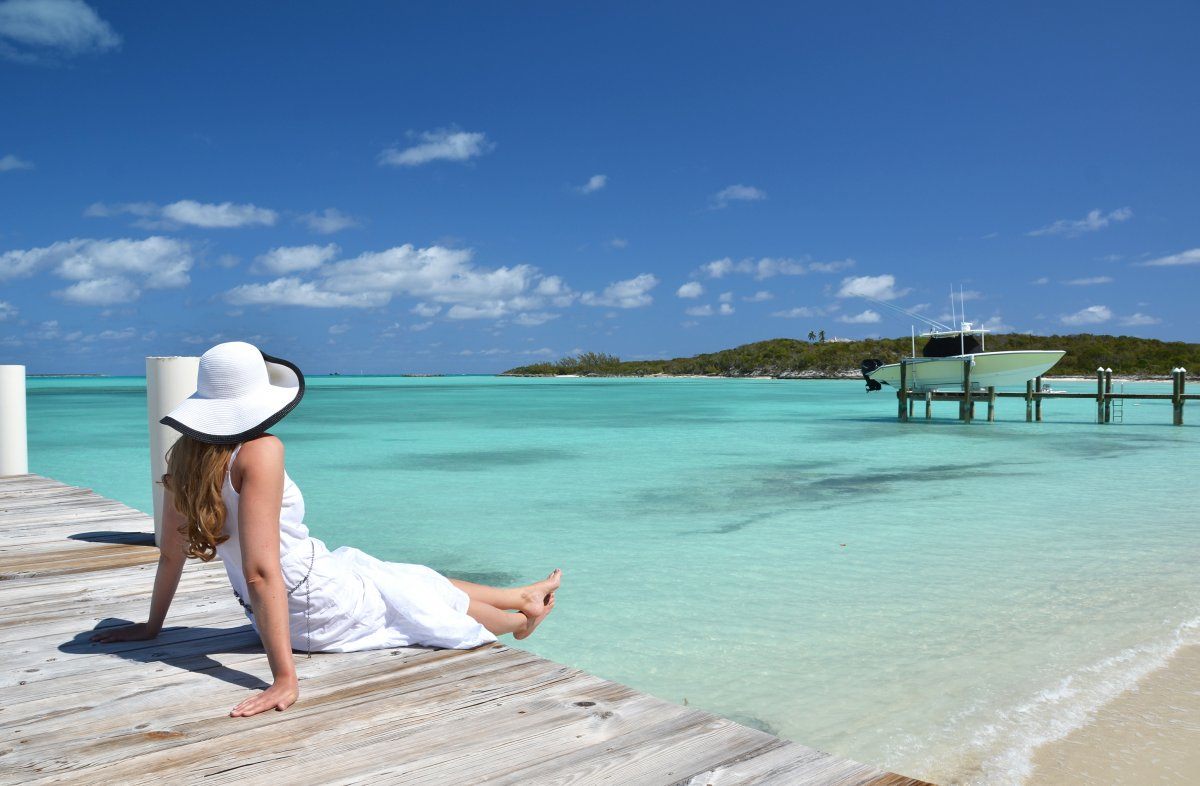 Girl On Wooden Jetty Looking Ocean