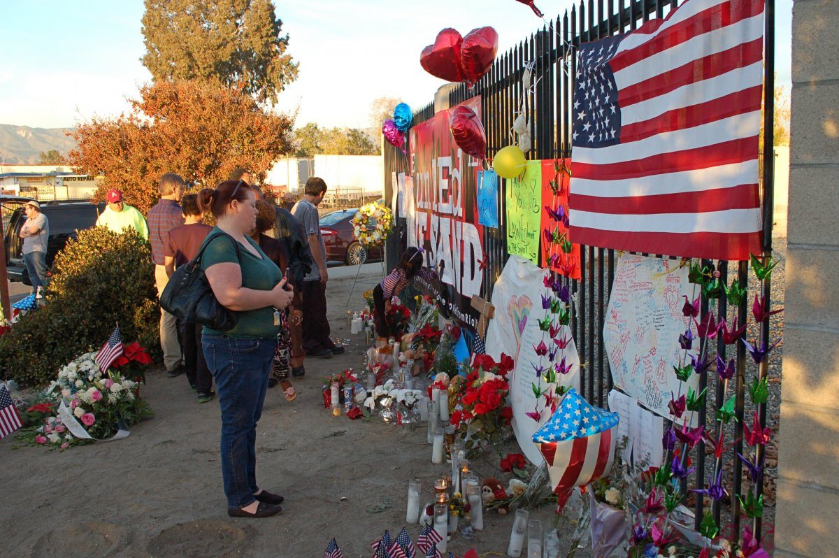 People visit a makeshift memorial to IRC shooting victims