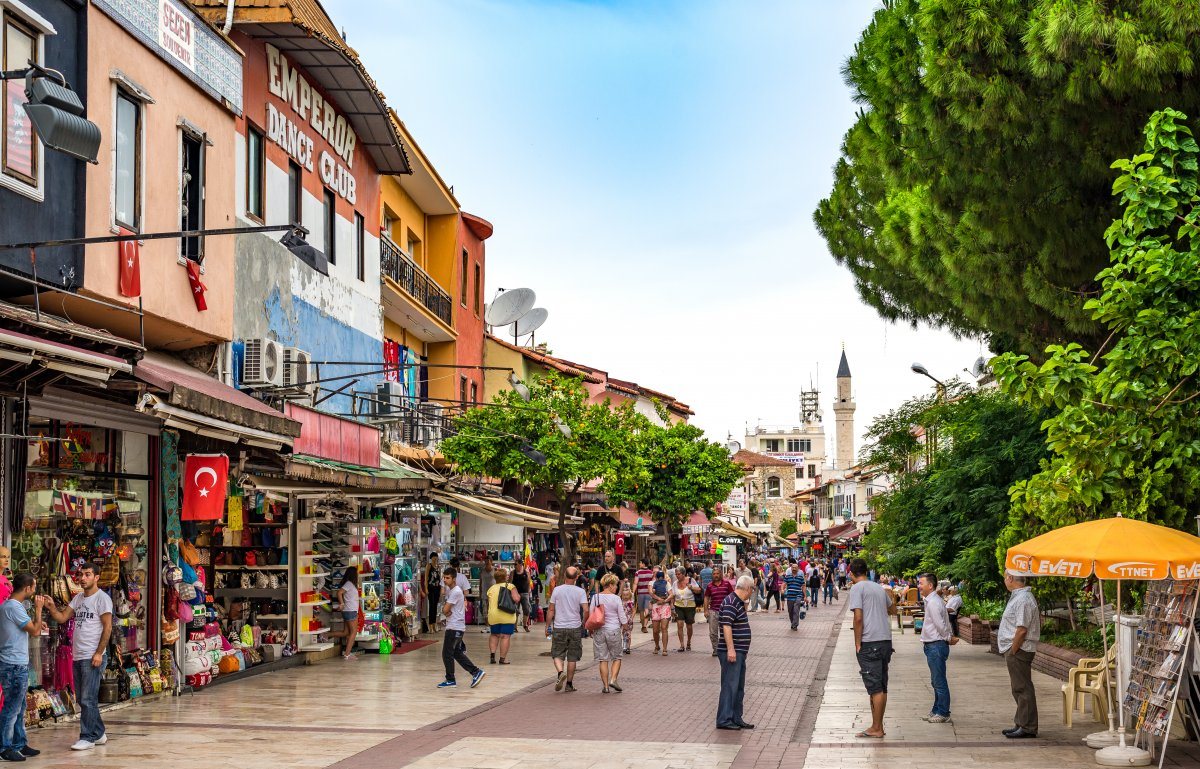 Tourists shop in stores along a bust street in Kusadasi, Turkey