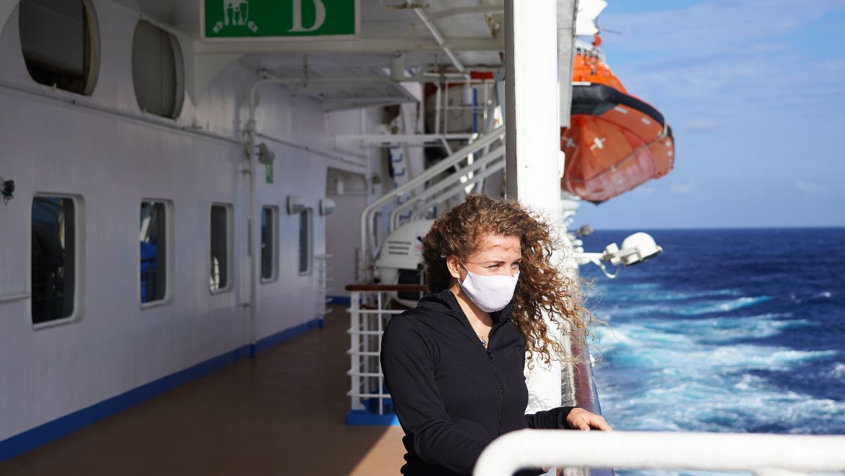 girl in medical mask on cruise ship or boat