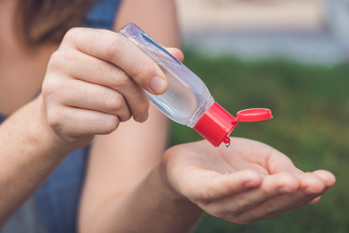 women's hands using wash hand sanitizer gel